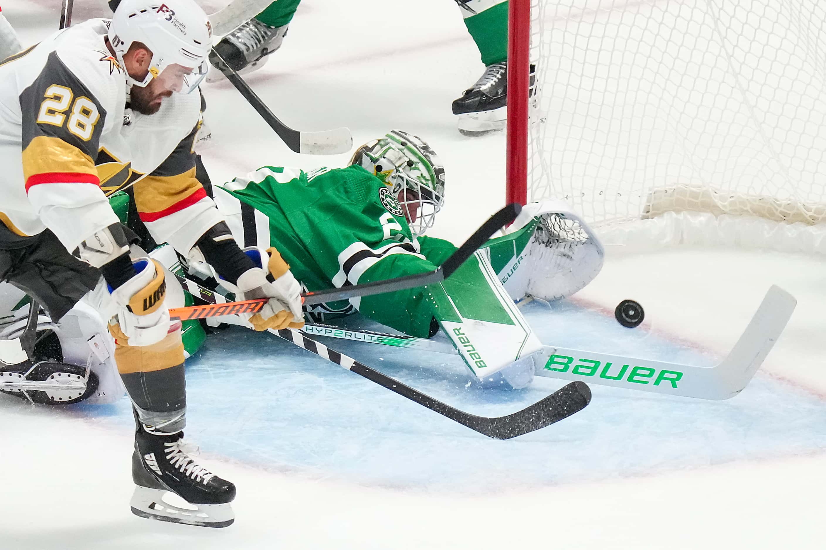 Vegas Golden Knights left wing William Carrier (28) slips the puck past Dallas Stars...