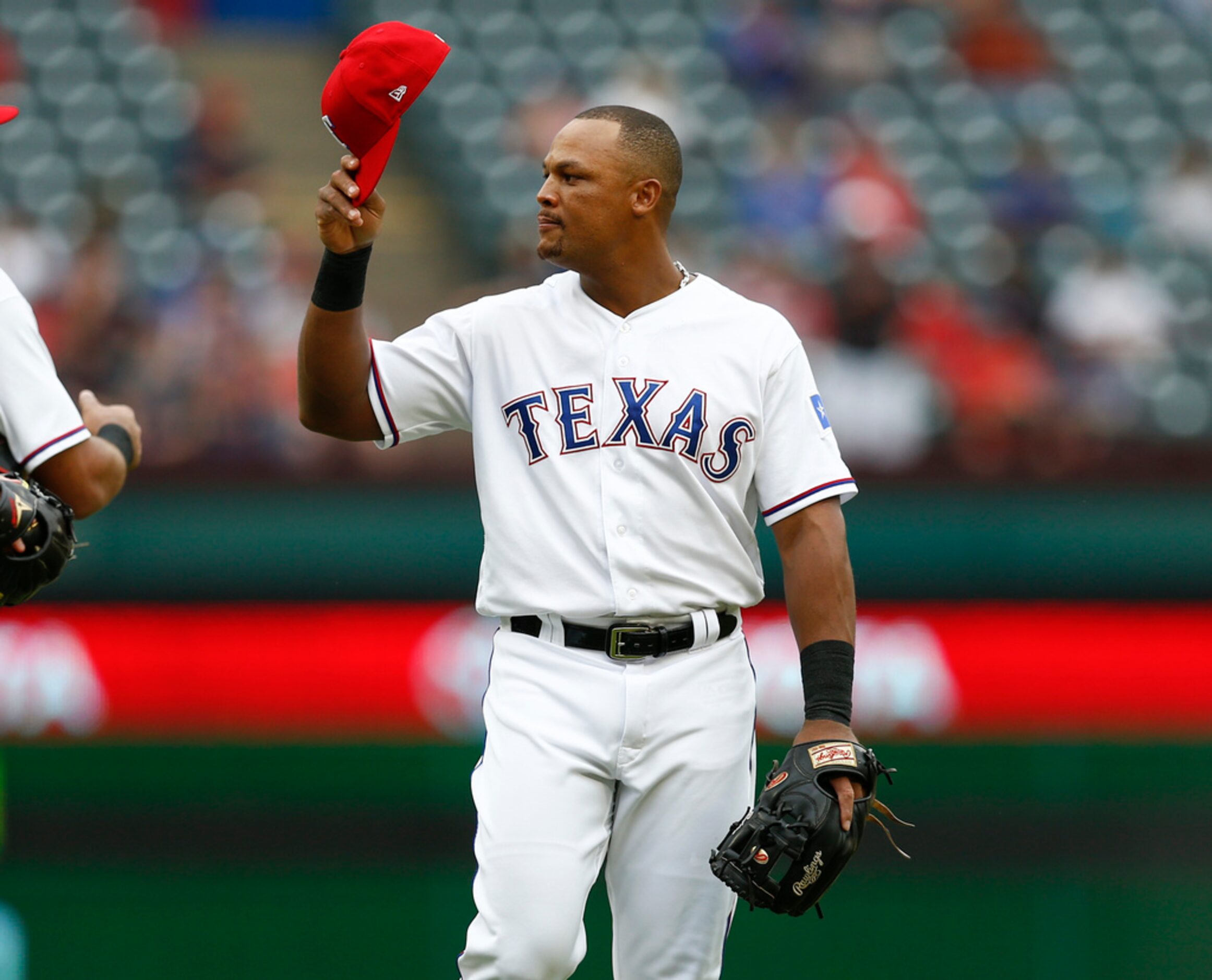 Texas Rangers' Adrian Beltre tips his cap to the Seattle Mariners bench after being relieved...