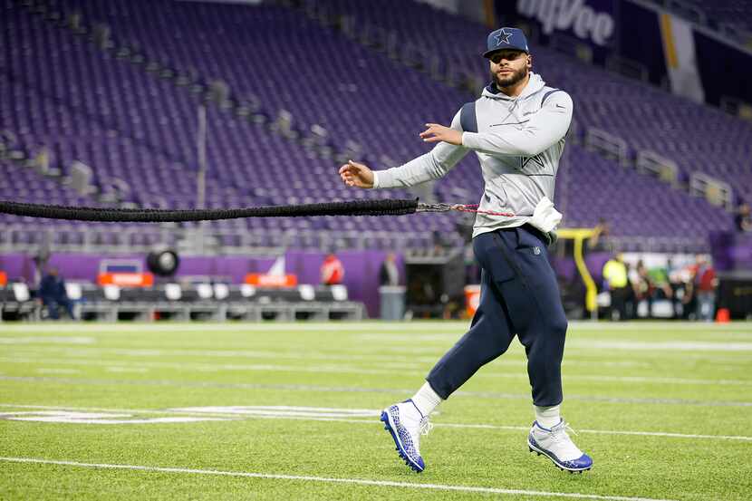 Dallas Cowboys quarterback Dak Prescott (4) stretches and warms up before their game against...