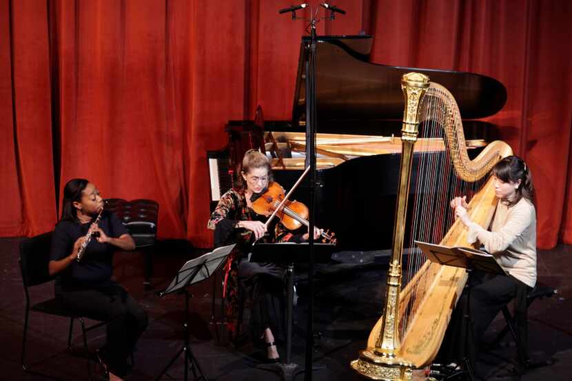 Ebonee Thomas, left, Barbara Sudweeks, and Yumiko Schlaffer perform during the Voices of...