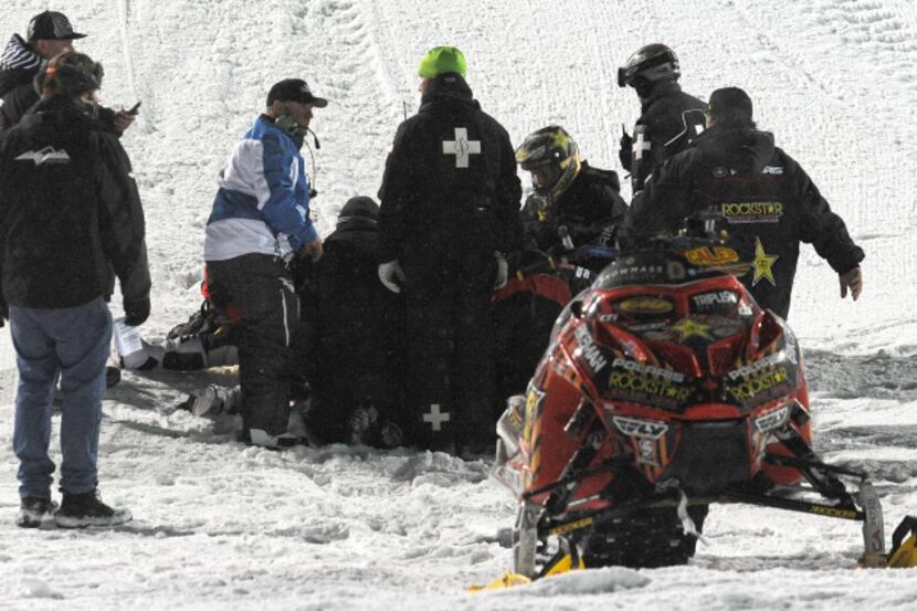 Emergency personnel tend to Caleb Moore after he crashed during the snowmoblie freestyle...