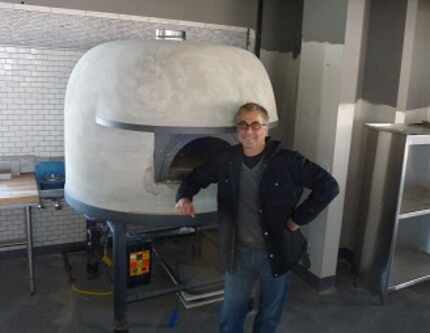 Chef-owner Daniele Puleo with his Stefano Ferrara Napoli wood-fired pizza oven at...