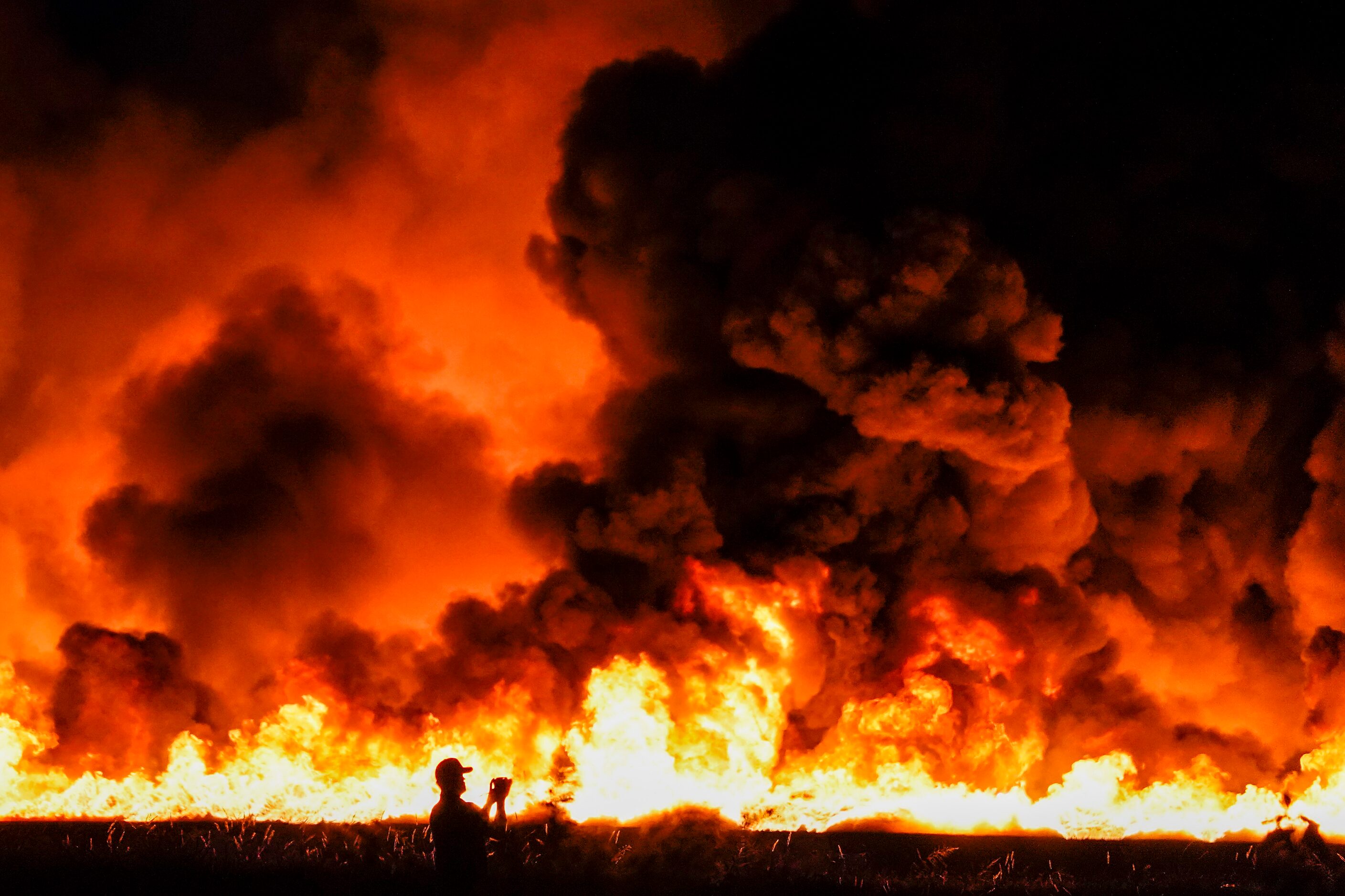 Fire crews battle a massive blaze in an industrial area of Grand Prairie in the early...