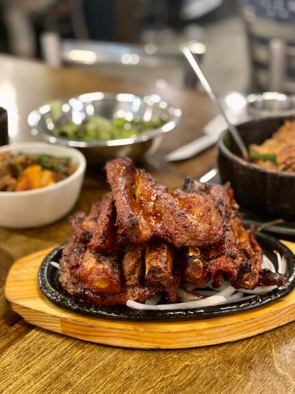 The ribs at Maht Gaek are smoky and charred, with a mildly spicy sauce that s baked into the...