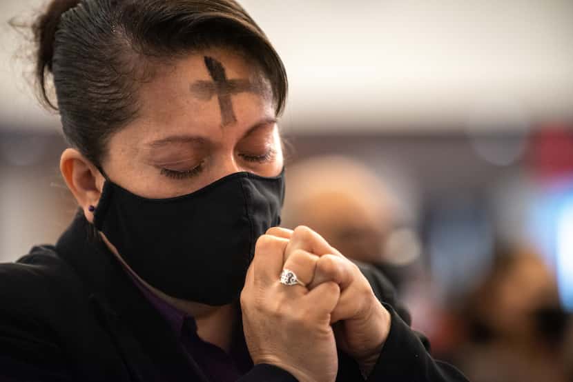 Parishioner Esmeralda Martinez prayed after receiving communion during the Ash Wednesday...