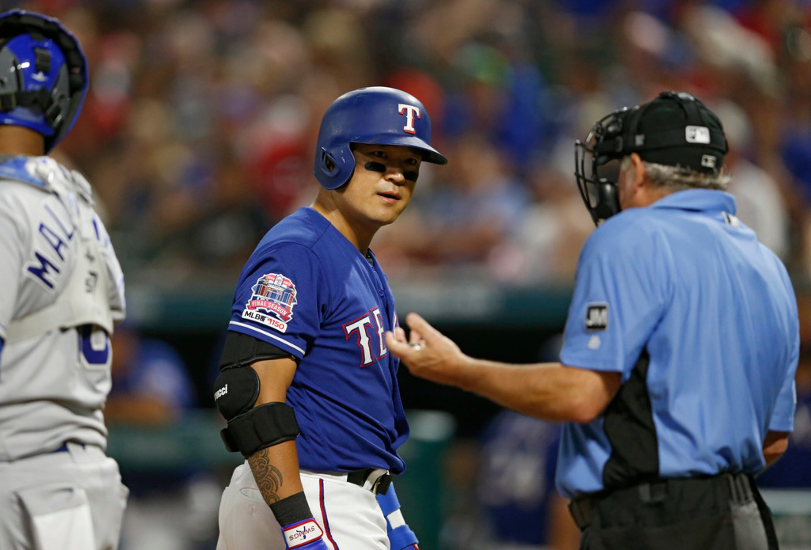 Texas Rangers right fielder Shin-Soo Choo (17) looks back at the umpire Tom Hallion (20)...