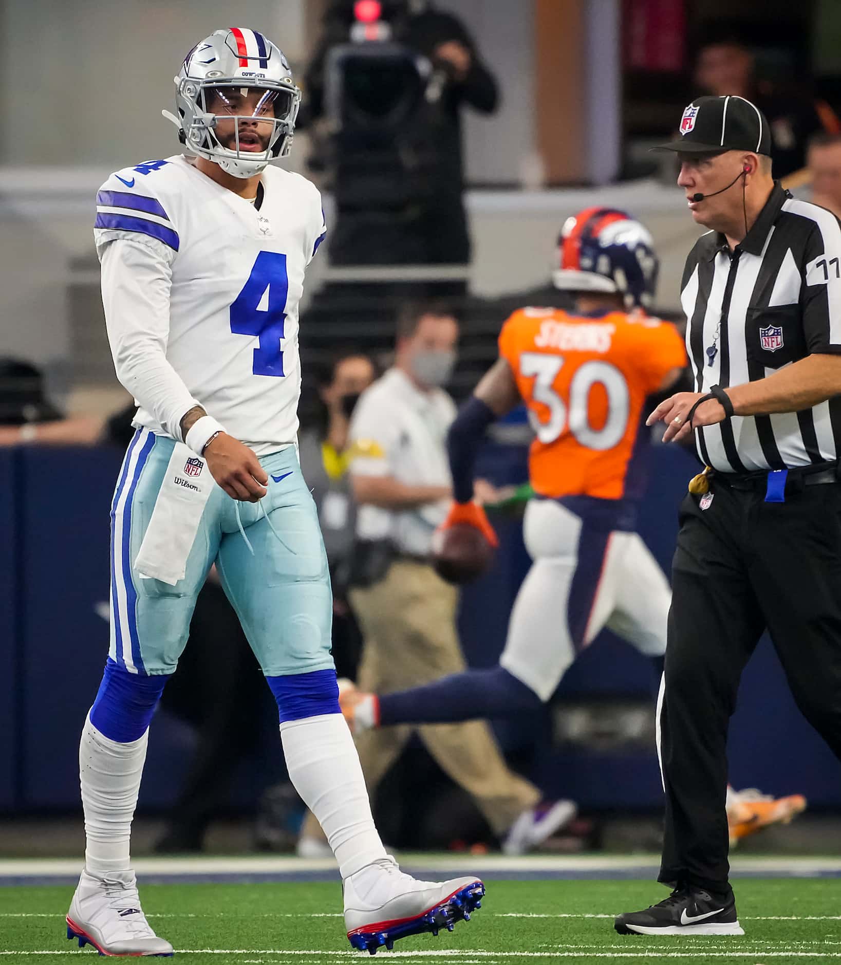 Dallas Cowboys quarterback Dak Prescott (4) walks to the bench after having a pass...
