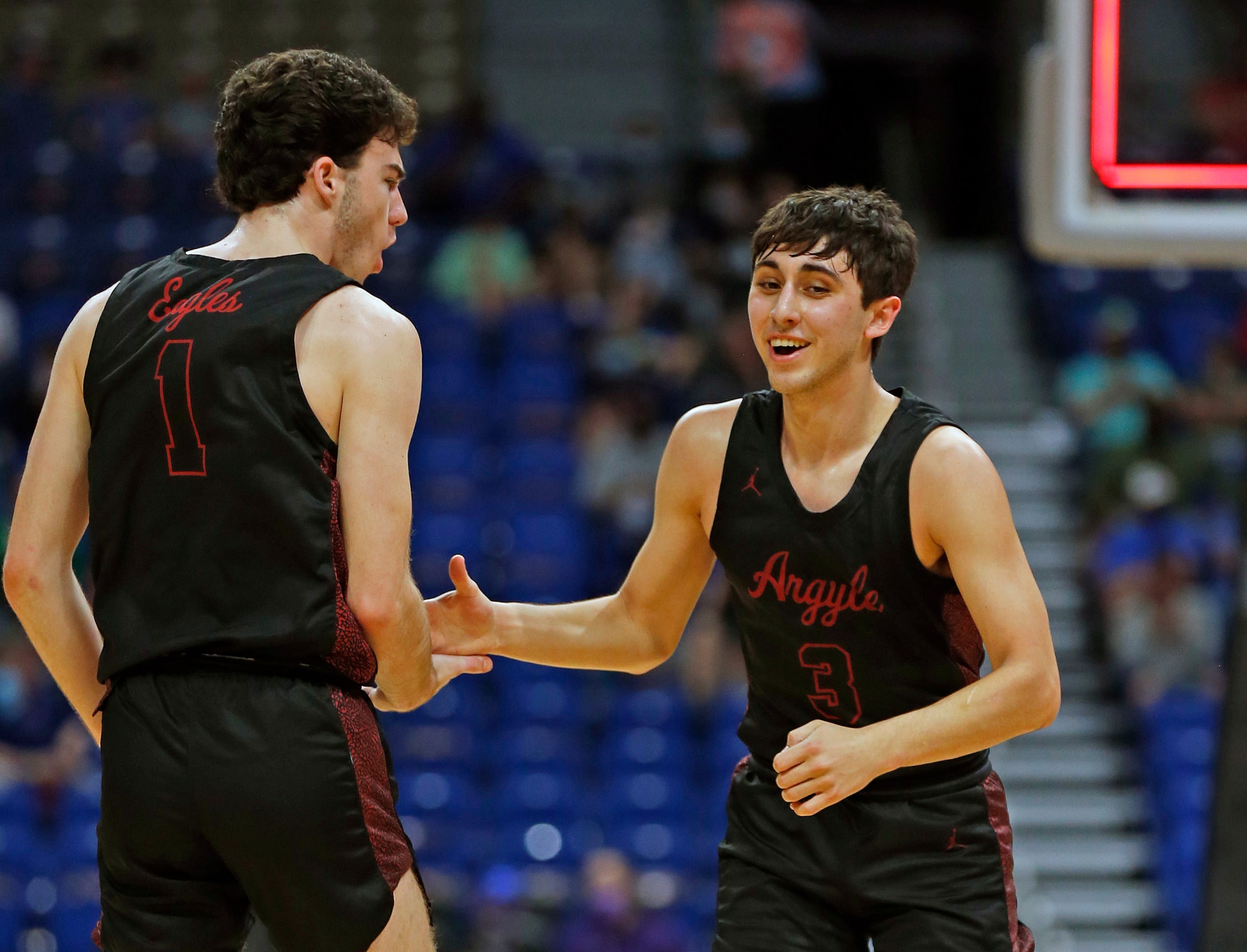 Argyle Skylar McCurry #3 is congratulated by Argyle Jacob Dye #1 after hitting a three. UIL...