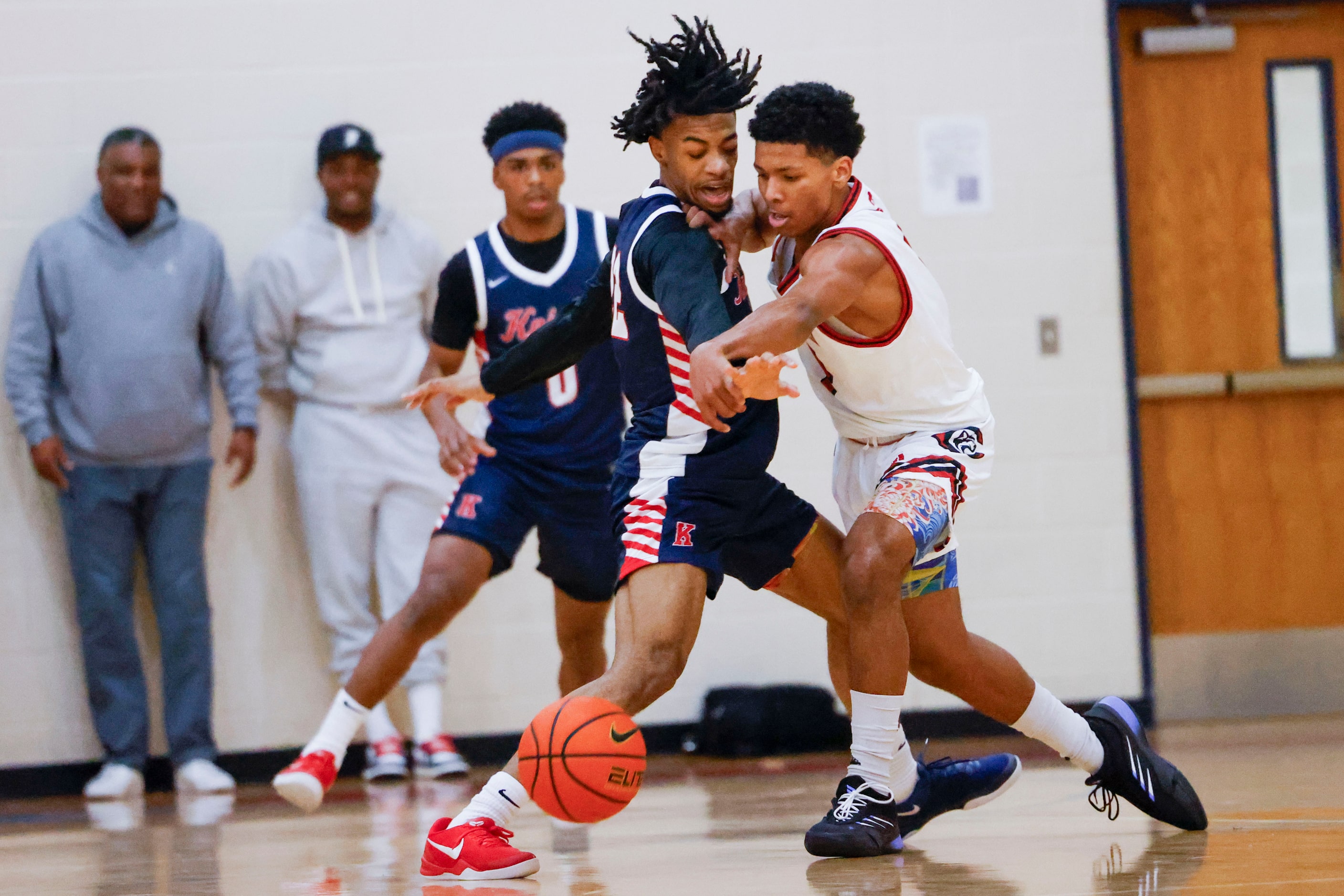 Kimball High’s Da’Marrion Wesley (left) clashes against Centennial High’s CJ Richardson...