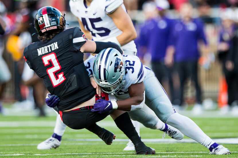 Desmond Purnell #32 of the Kansas State Wildcats brings down Behren Morton #2 of the Texas...