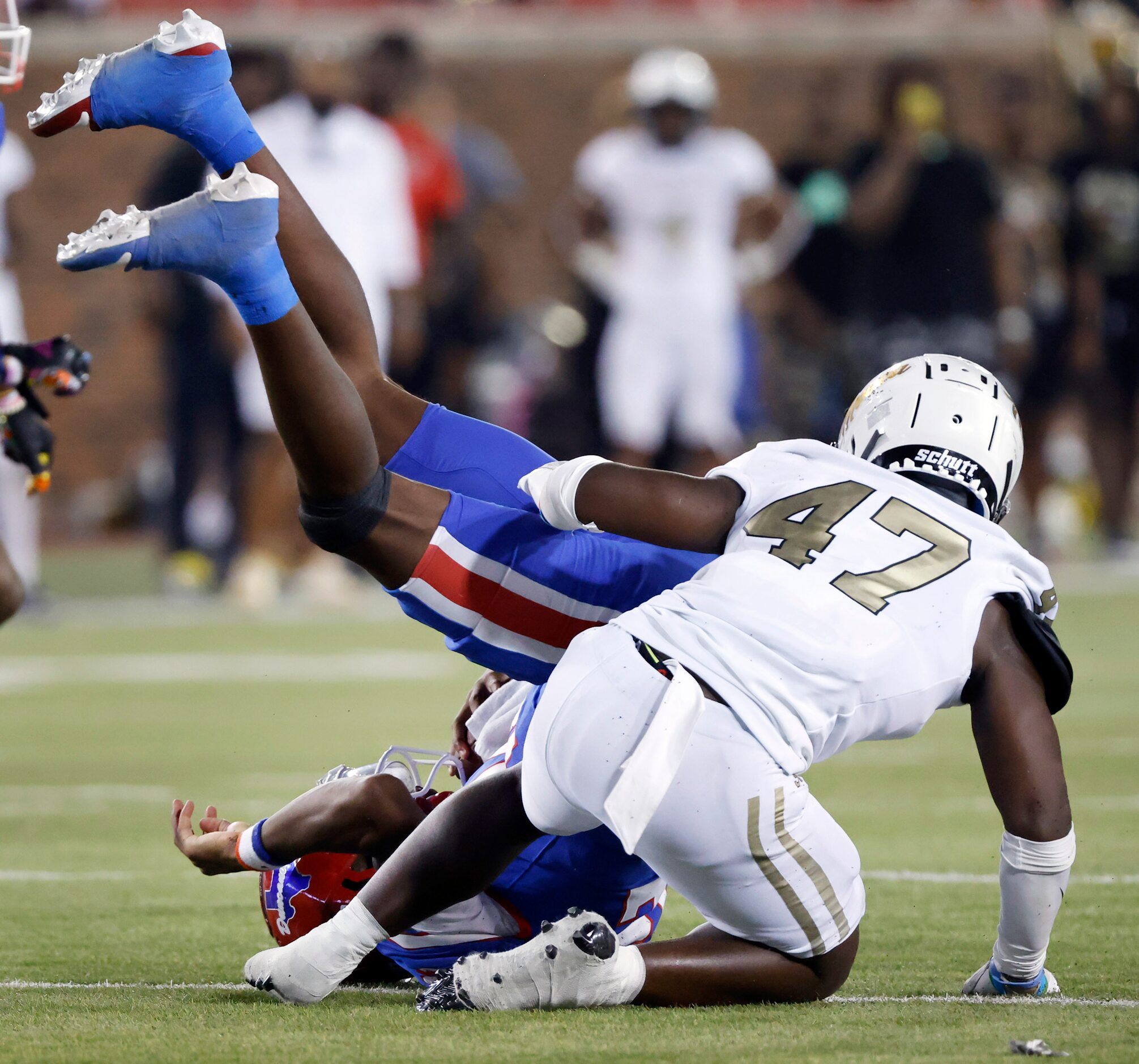 Duncanville quarterback Keelon Russell (12) is rolled up by South Oak Cliff linebacker Perry...