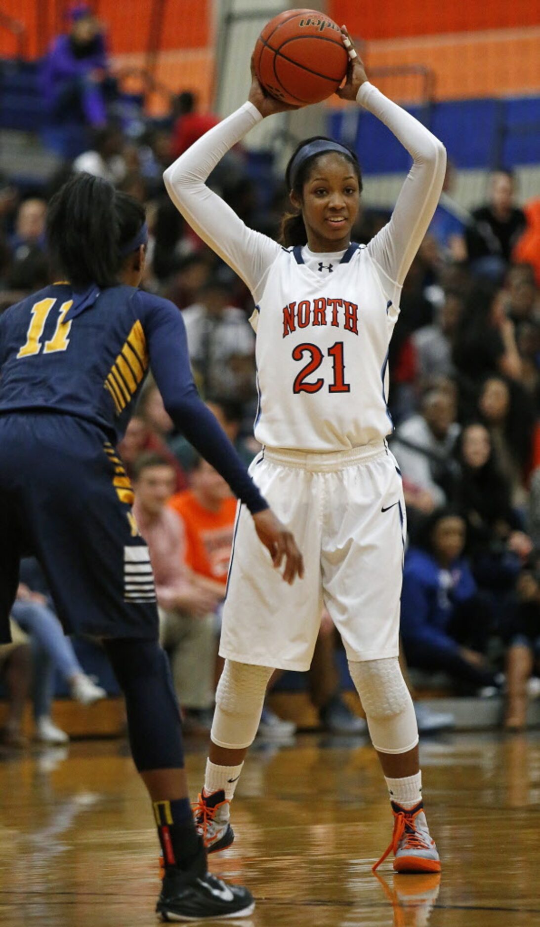 McKinney North's Chanterria Jackson (21) makes a pass as she is defended by McKinney's...