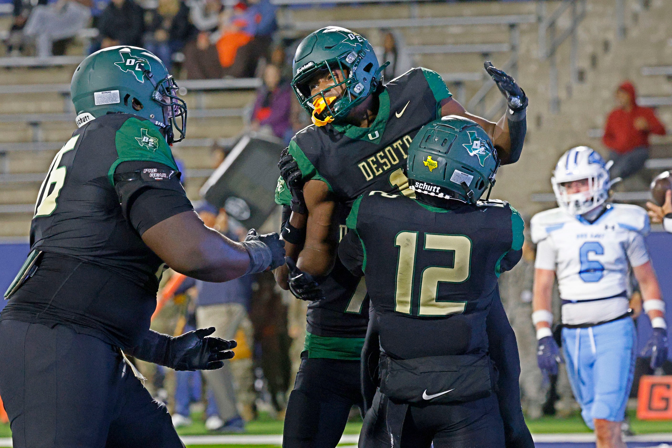 DeSoto's Deondrae Riden Jr. (1), center, celebrates with his teammates  Byron Washington...