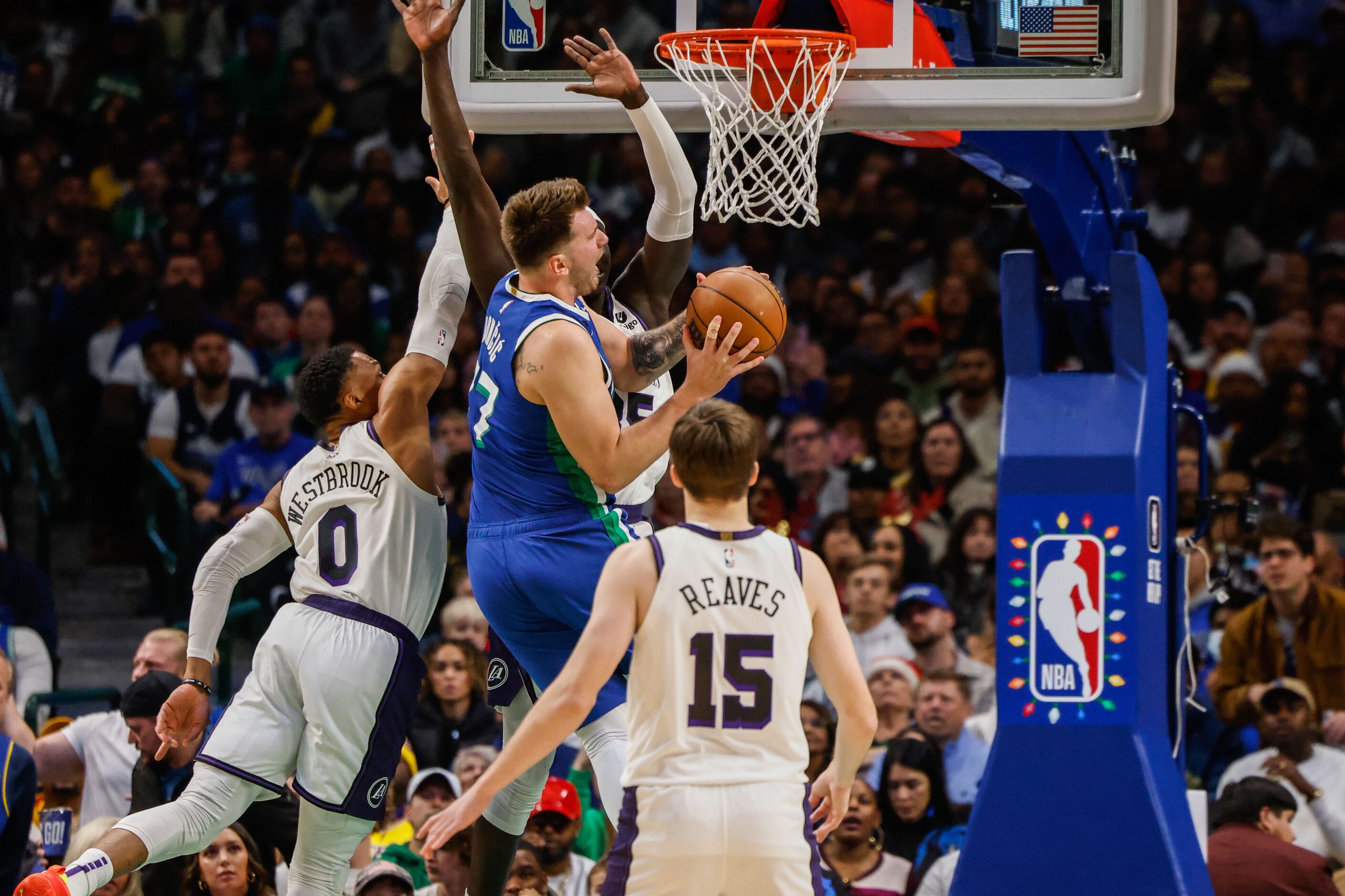 Dallas Mavericks guard Luka Doncic (77) goes for a shot while Los Angeles Lakers guard...