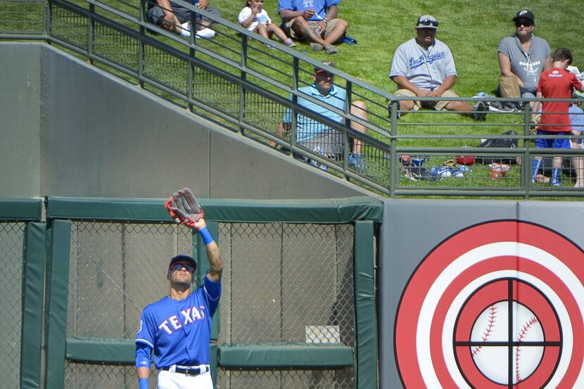 Texas Rangers left fielder Ian Desmond (20) gets used to his new position during the first...