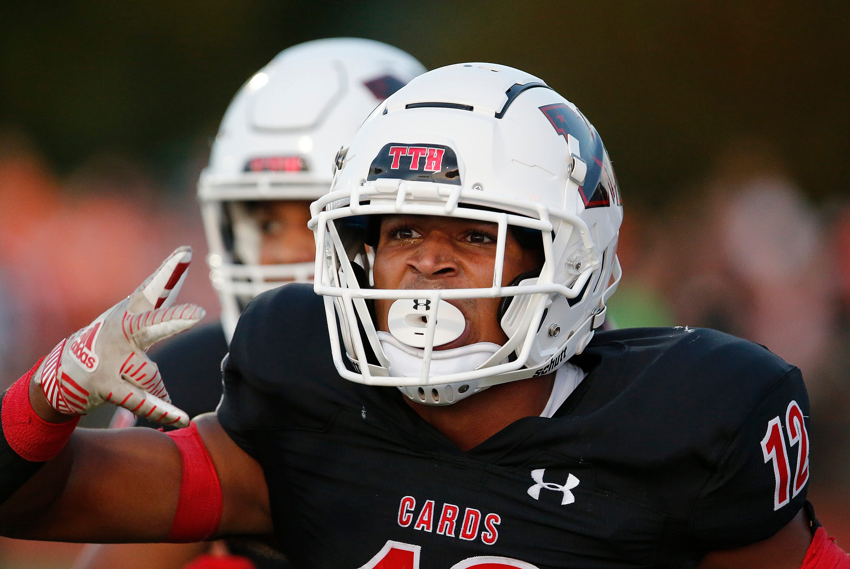 Melissa High School running back Ashton Mitchell-Johnson (12) celebrates scoring a touchdown...