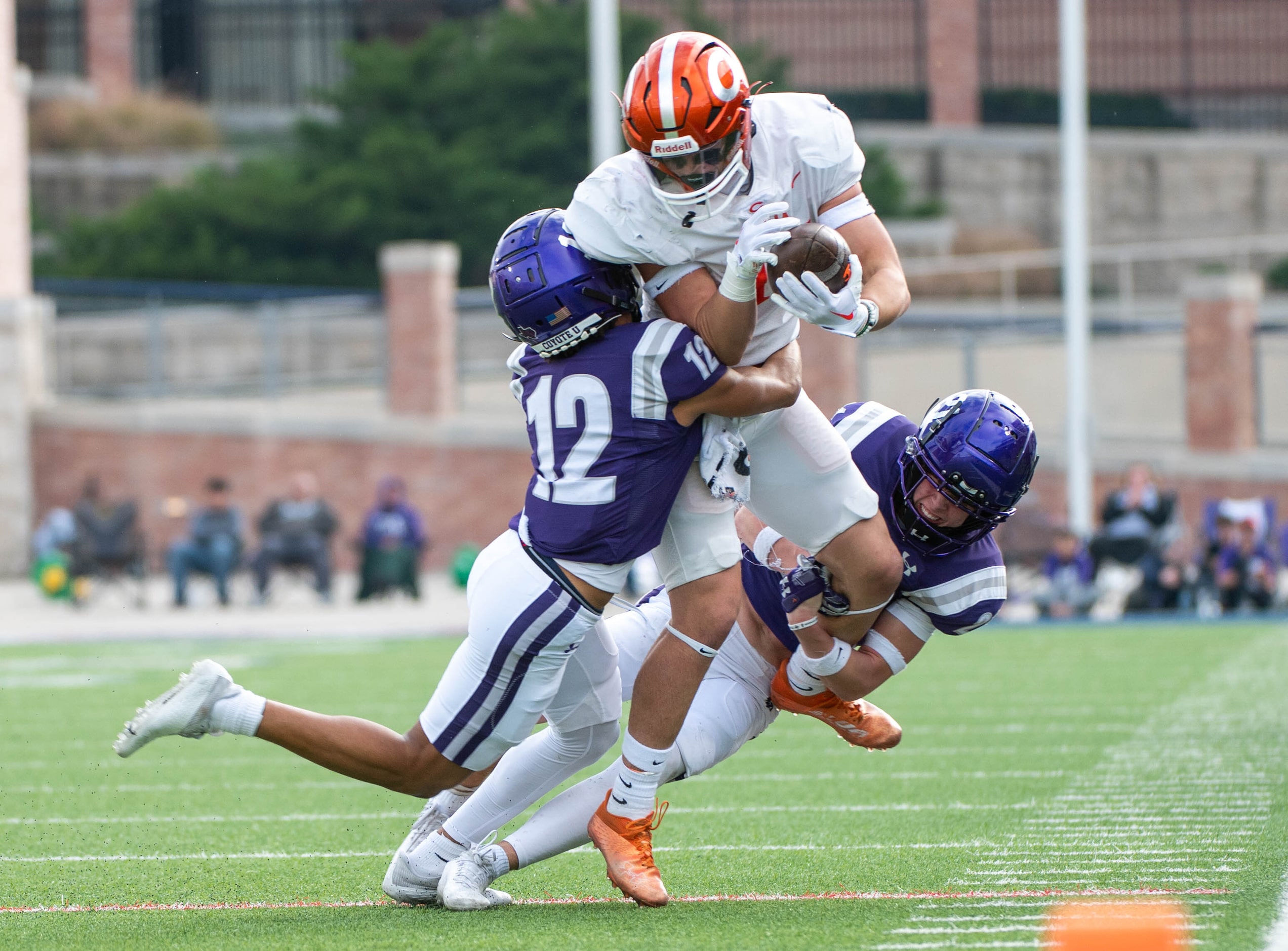 Anna cornerback Elijah Robertson (12) and free safety Roman Frazier (21) tackle Celina's...