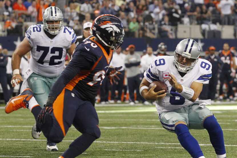 Dallas Cowboys quarterback Tony Romo (9) is stopped on a two-point conversion by Denver...