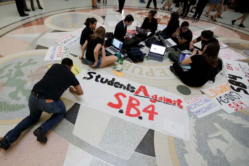 Students gathered in the rotunda at the Texas Capitol during the legislative session to...