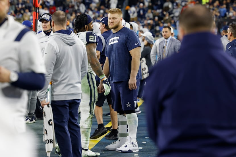 Dallas Cowboys center Tyler Biadasz returned from the locker room in street clothes after...