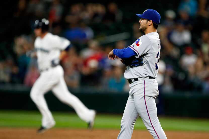 Sep 9, 2015; Seattle, WA, USA; Texas Rangers pitcher Martin Perez (33) walks around the...