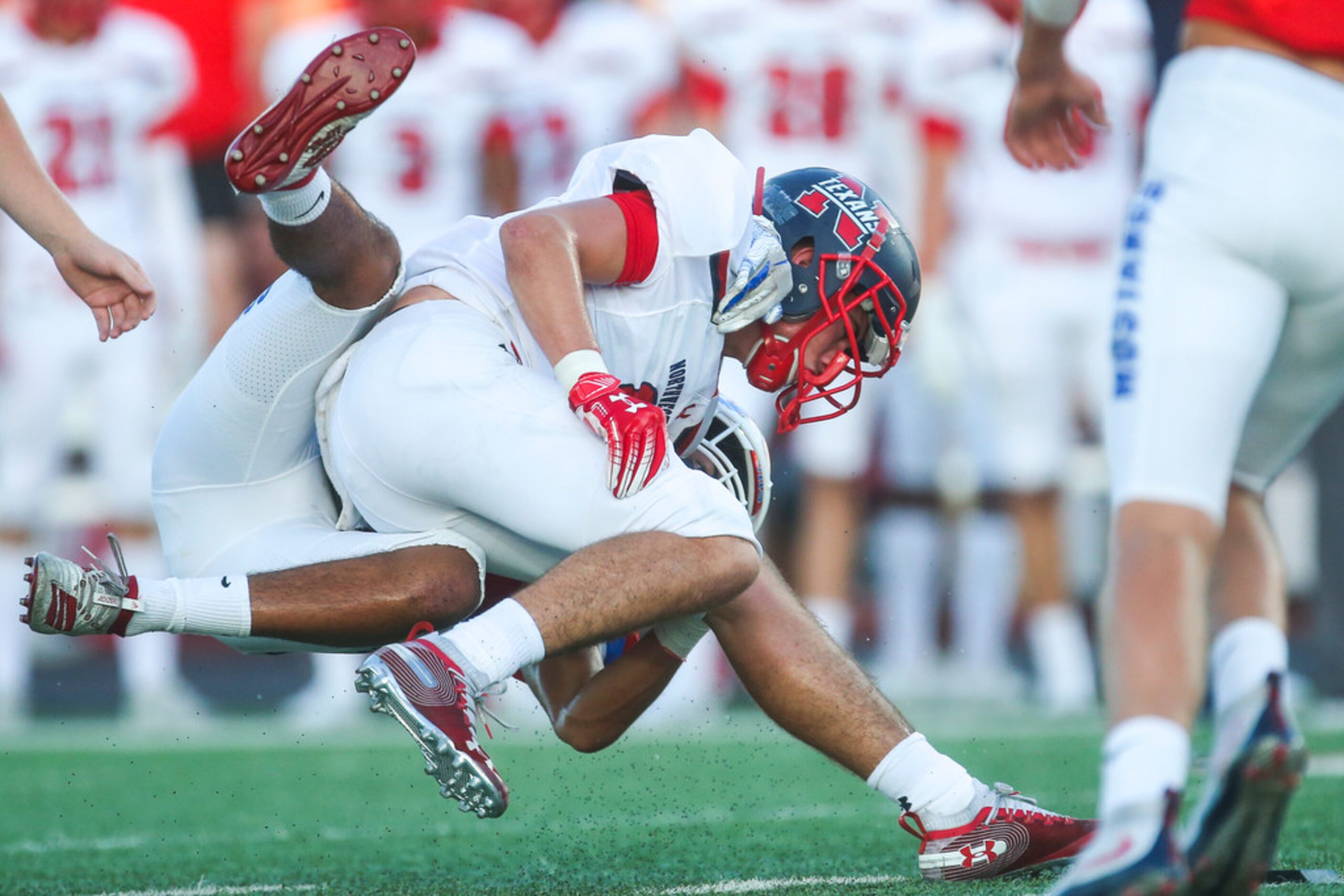 Grapevine defensive back Adriene White (21) brings down Northwest's Weldon Sherrell (6)...