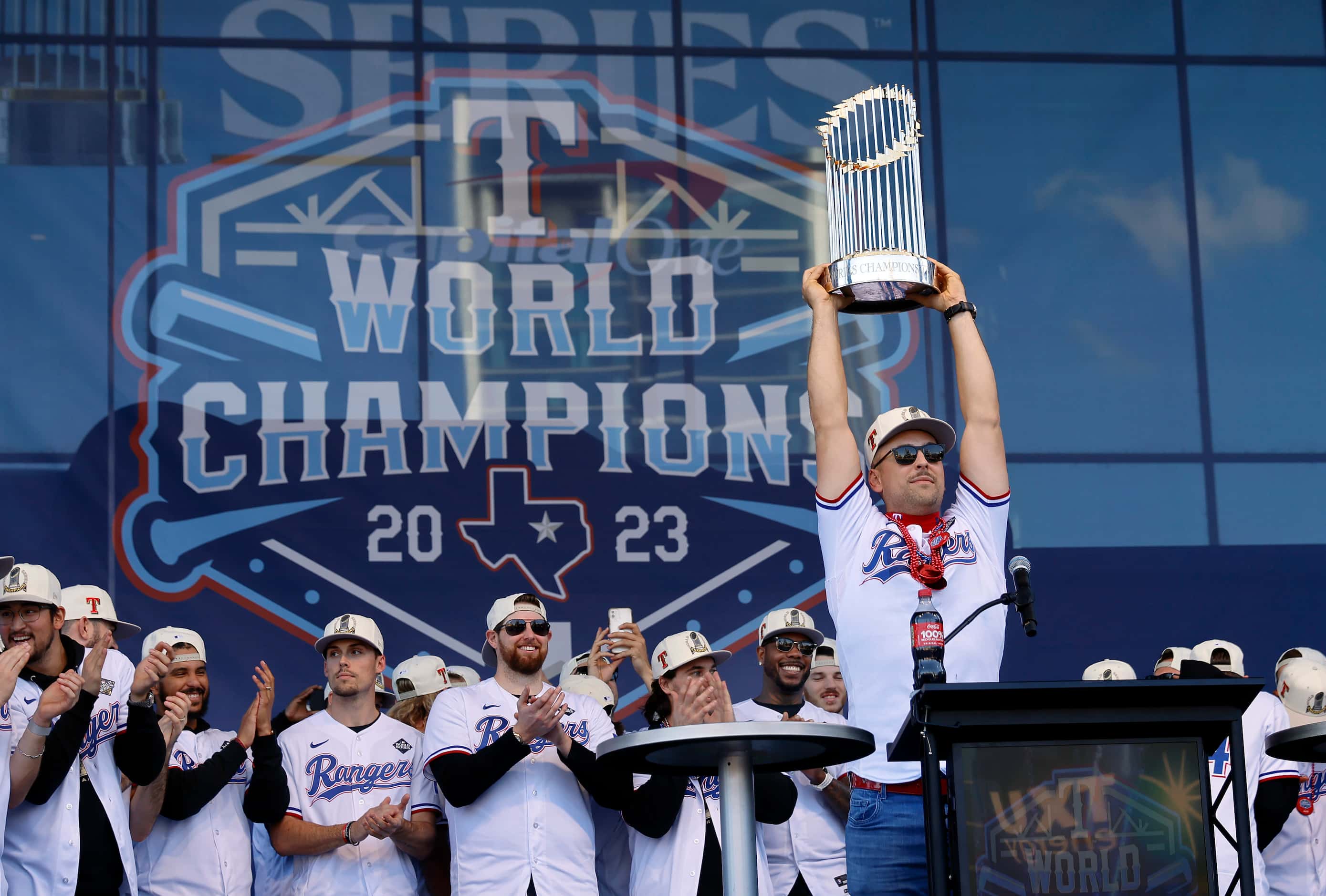 Texas Rangers first baseman Nathaniel Lowe hoists the Commissioner's Trophy during a...