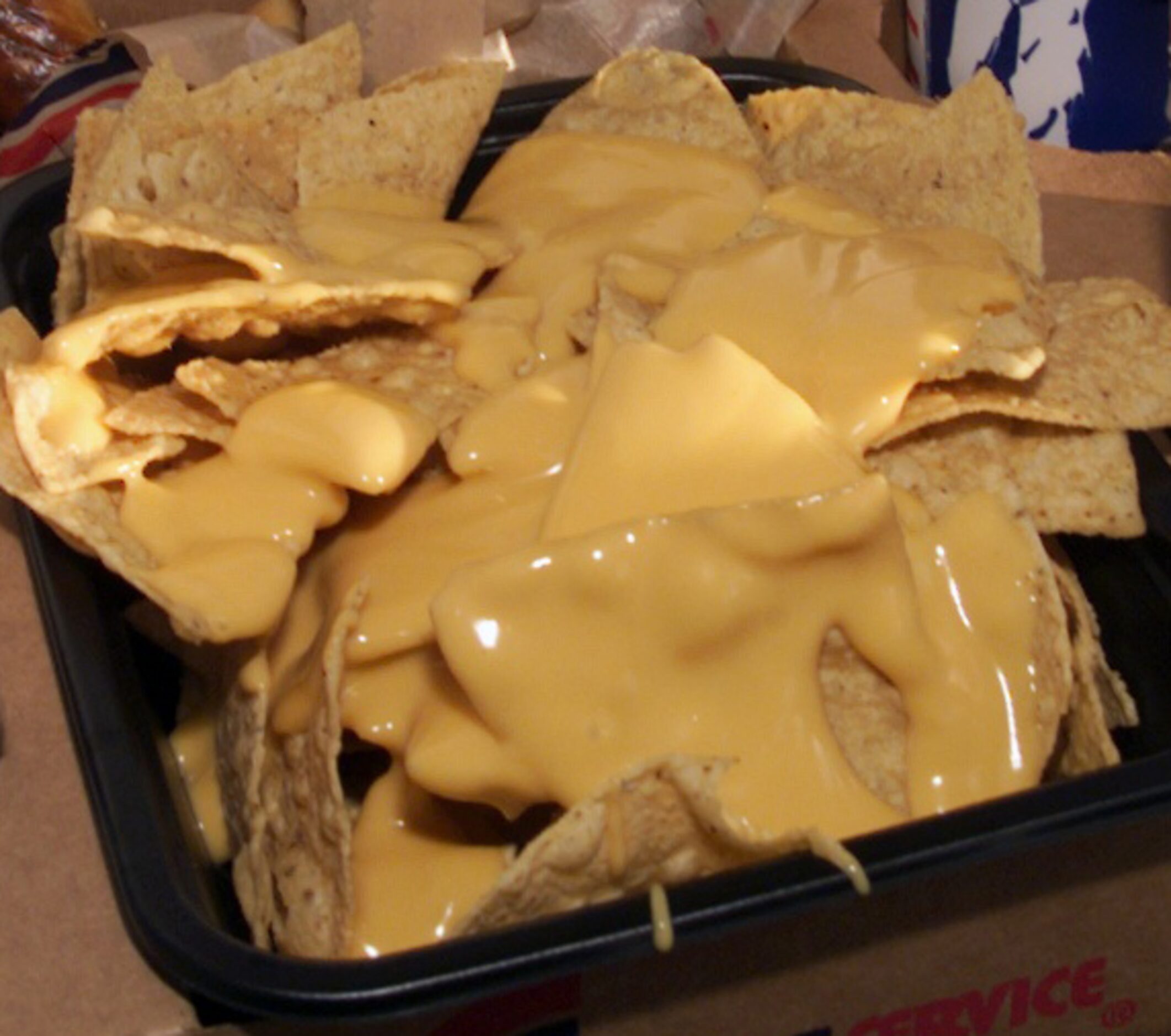 A platter of nachos from a 1999 photo taken at The Ballpark in Arlington. The cheesy...