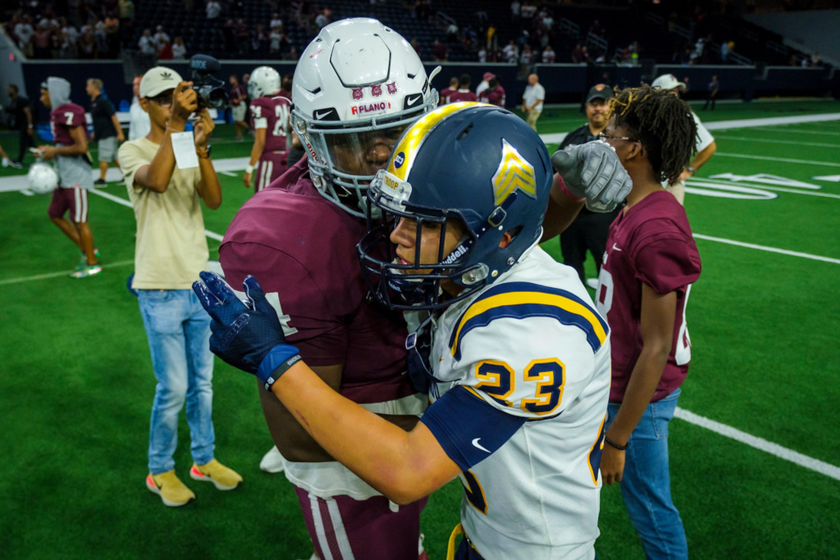 Plano lineman Jalen Anderson (74) hugs El Paso Eastwood strong safety Patrick Avila (23)...