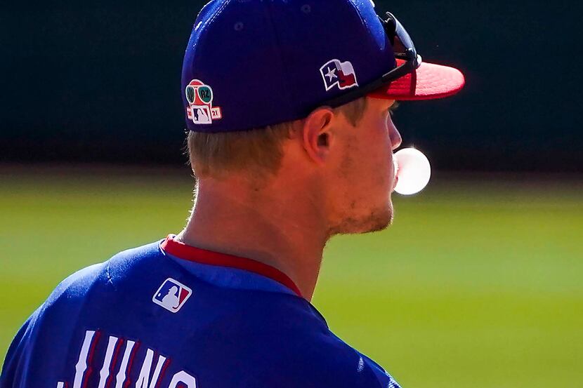 Texas Rangers infielder Josh Jung blows a bubble between pitches during the fifth inning of...