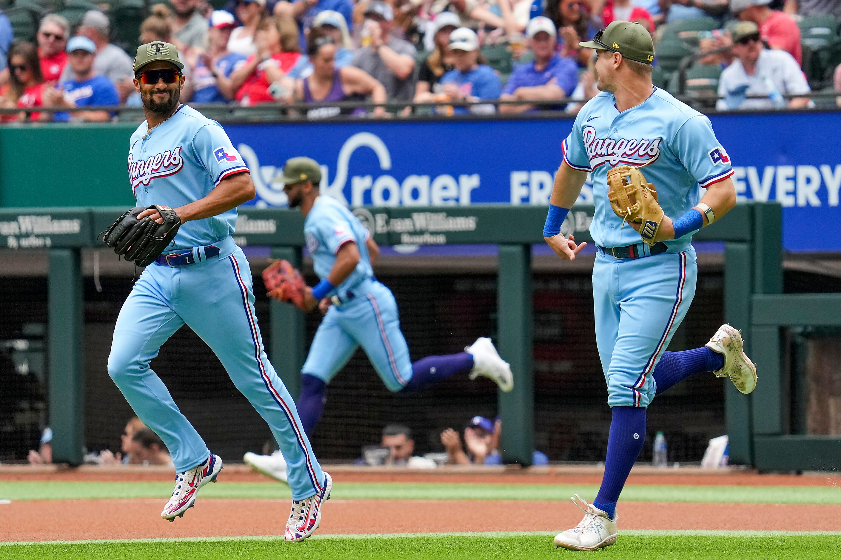 Texas Rangers second baseman Marcus Semien (left) and third baseman Josh Jung take the field...