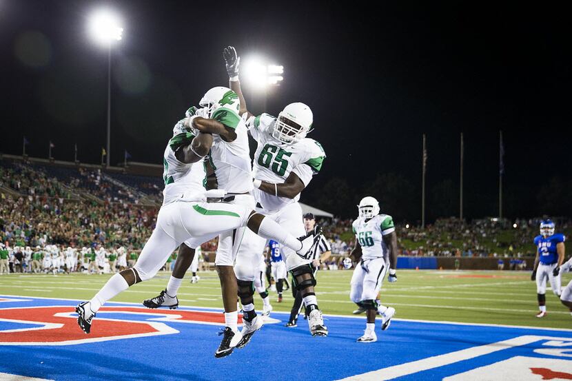 North Texas running back Antoinne Jimmerson (22) celebrates with teammates after scoring on...