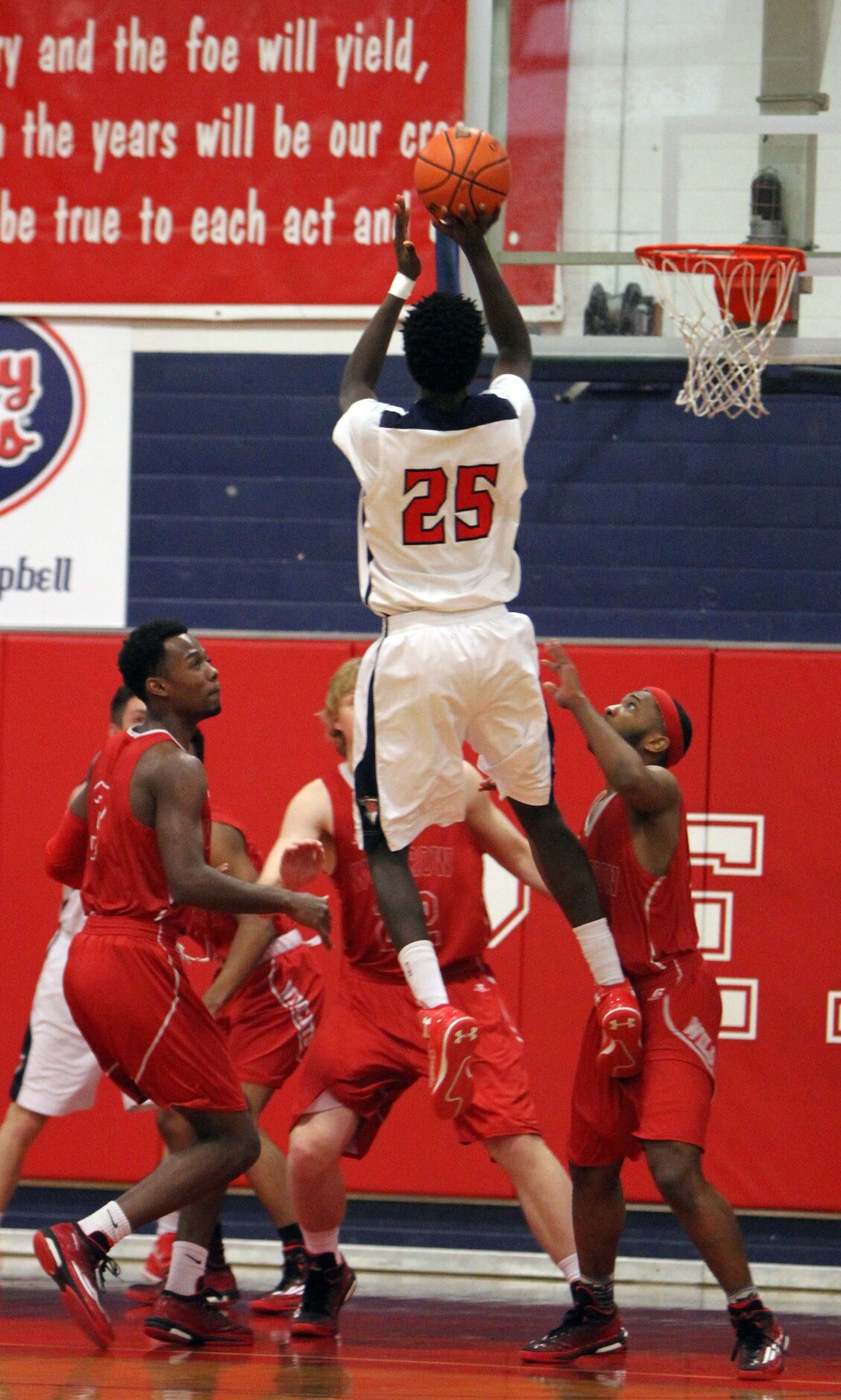 Frisco Centennial forward Jonathyn Washington (25) goes high to deliver a jump shot over the...