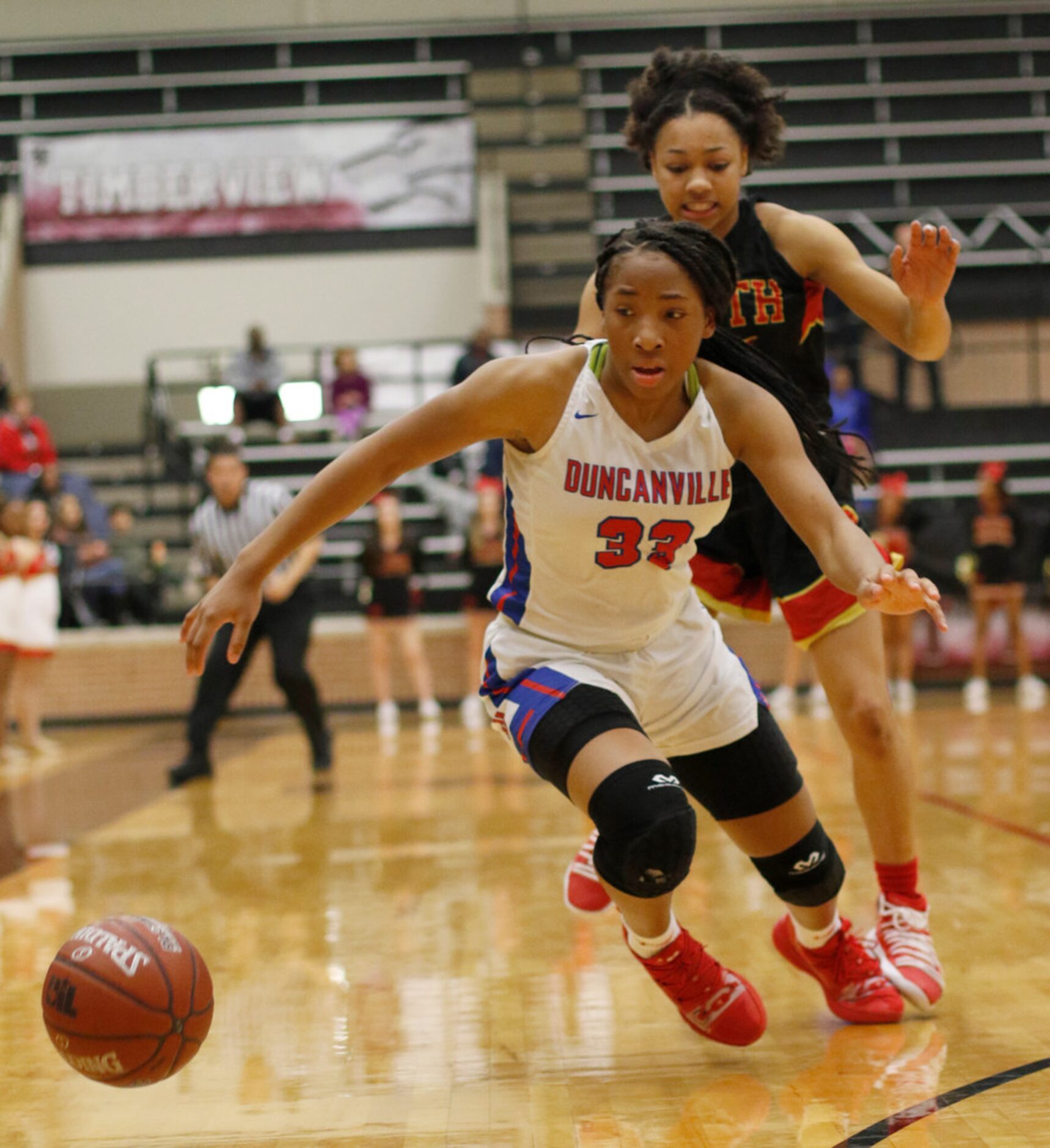 Duncanville guard Nyah Wilson (33) lunges to save the ball from bouncing out of bounds as...