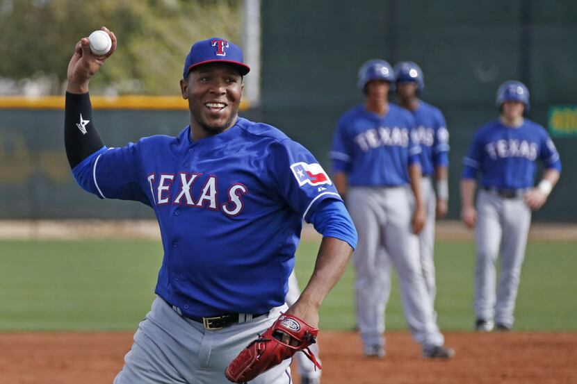 Texas pitcher Neftali Feliz works during rundown drills during Texas Rangers baseball spring...