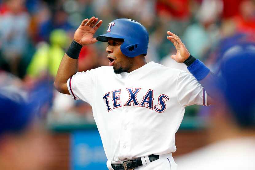 FILE - Texas Rangers Elvis Andrus celebrates after scoring on a third inning single by...