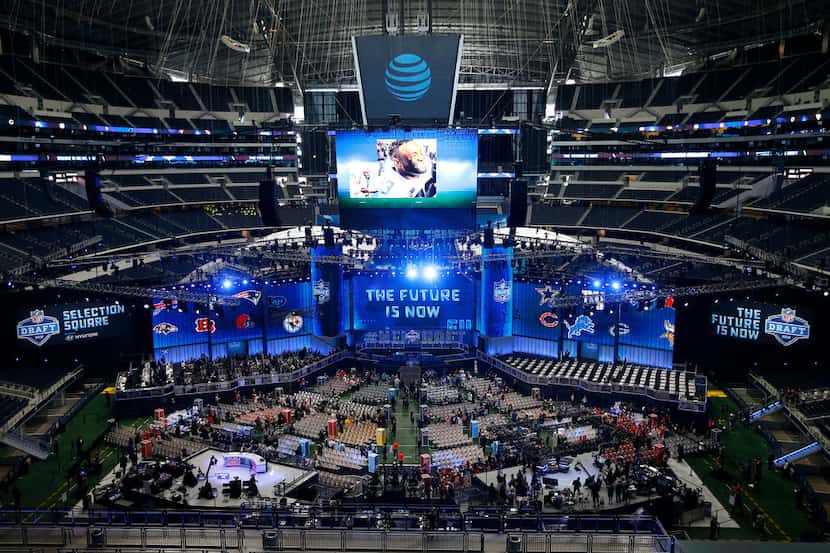 NFL fans walk in to the floor to watch the first round of the NFL draft at AT&T Stadium in...