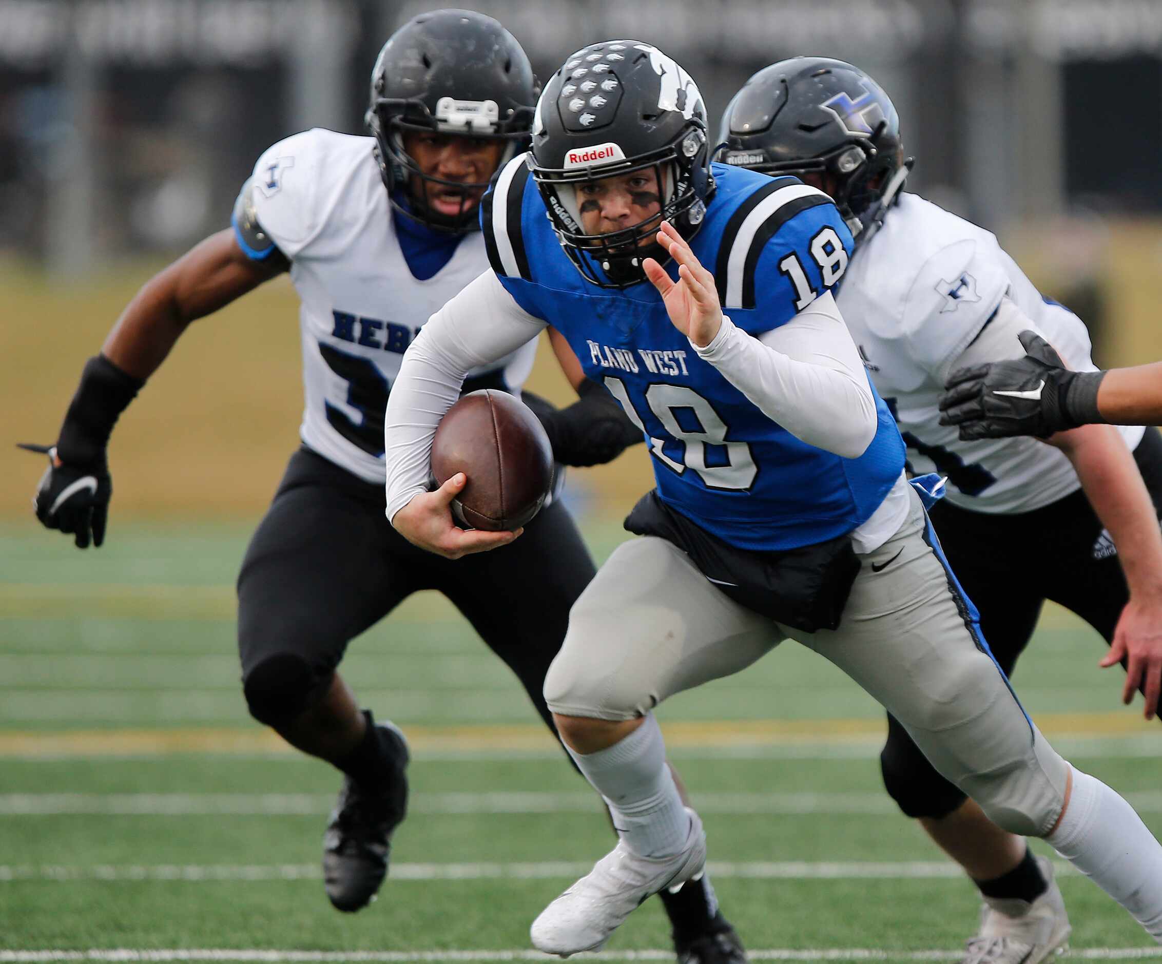 Plano West High School quarterback Greg Draughn (18) scrambles during the second half as...