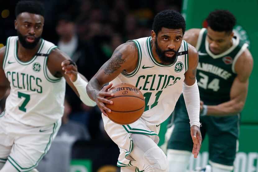 Boston Celtics' Kyrie Irving (11) brings the ball up court during the second half of Game 4...