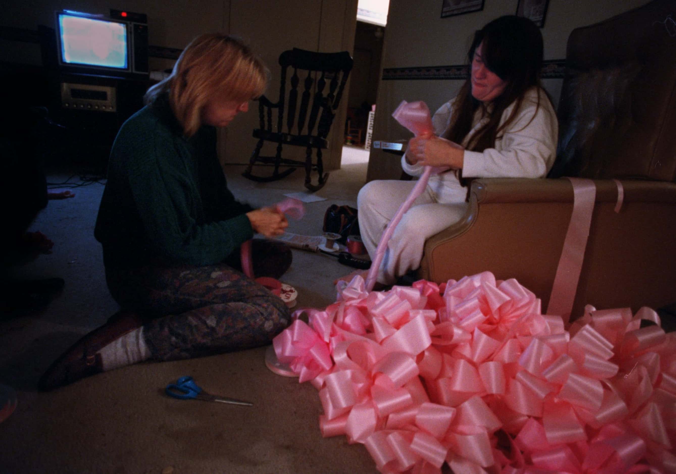 Barbara Dyess and Tammy Zimmerman make pink bows at 3 a.m. on Jan. 18, 1996 for Amber...