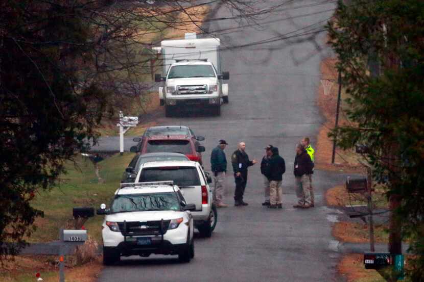 Investigators stood near where the body of Bradley William Stone was discovered Tuesday in...