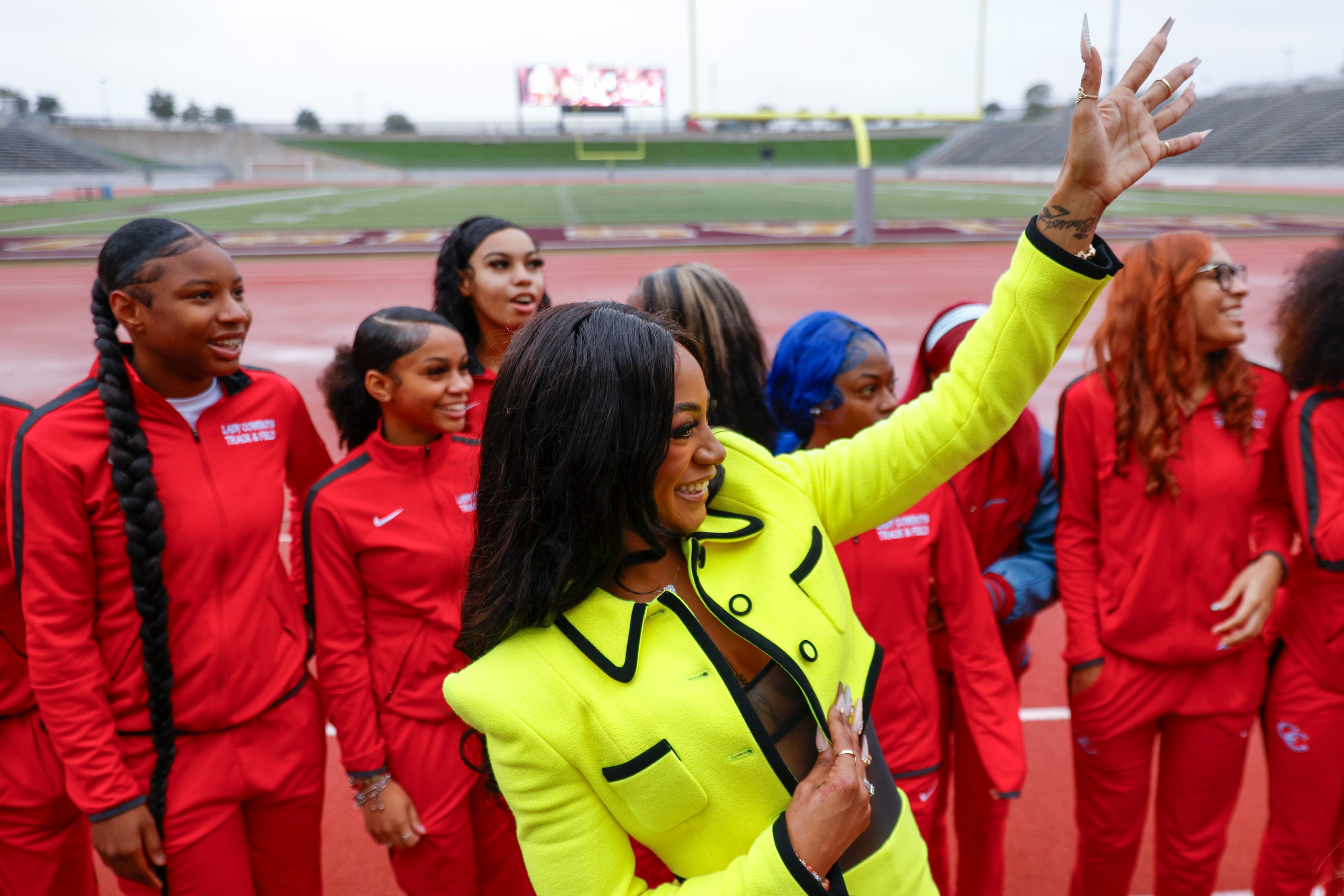 100 meters world champion Sha'Carri Richardson, (center), alongside David W. Carter High...