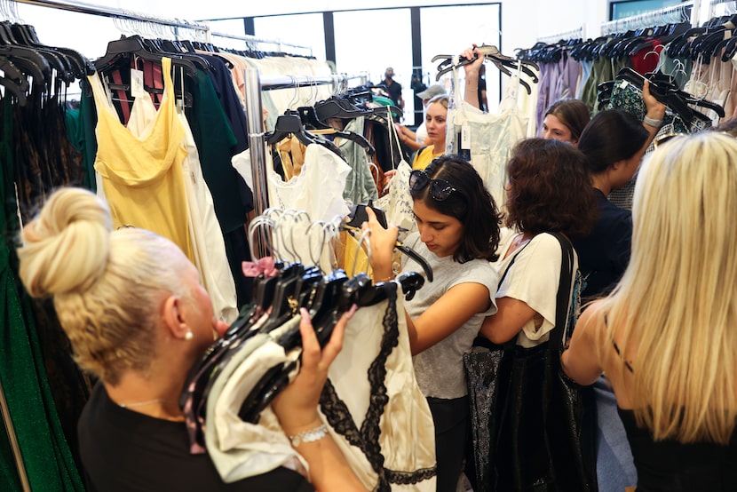 Customers check out different sample items at the store.