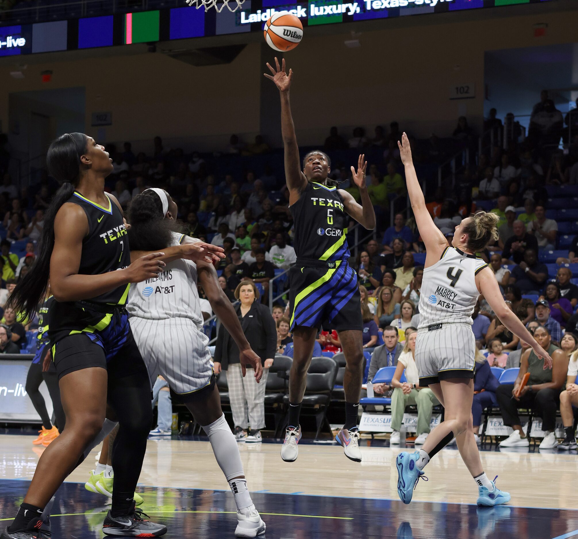 Dallas Wings forward Natasha Howard (6) gets off a jump shot as she is defended by Chicago...