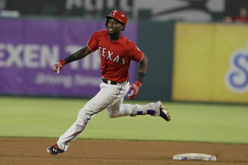 Texas Rangers Jurickson Profar rounds second base on his way to a tripple during the seventh...