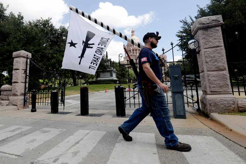 Gun rights advocates gather outside the state Capitol in Austin where Gov. Greg Abbott held...