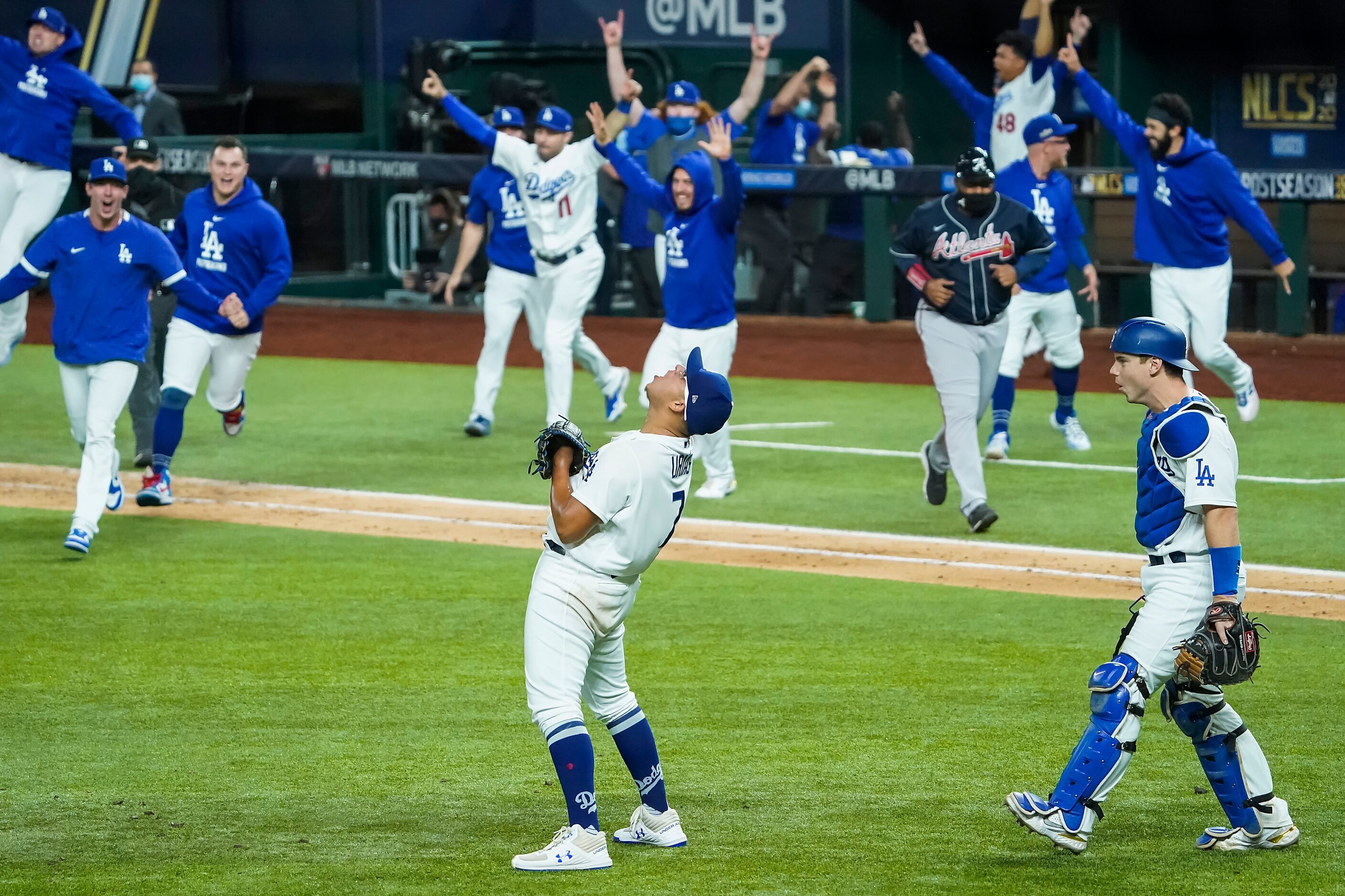 Los Angeles Dodgers pitcher Julio Urias (7) celebrates as the dugout empties after the final...