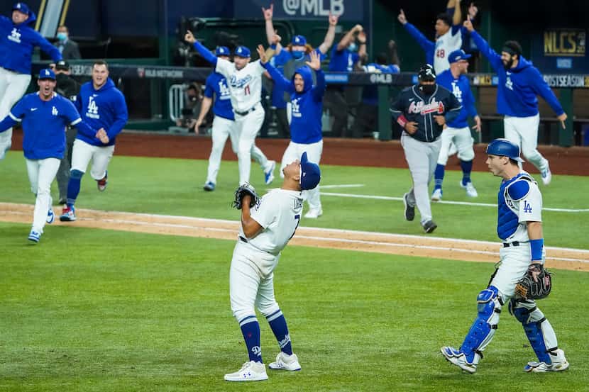 Los Angeles Dodgers pitcher Julio Urias (7) celebrates as the dugout empties after the final...