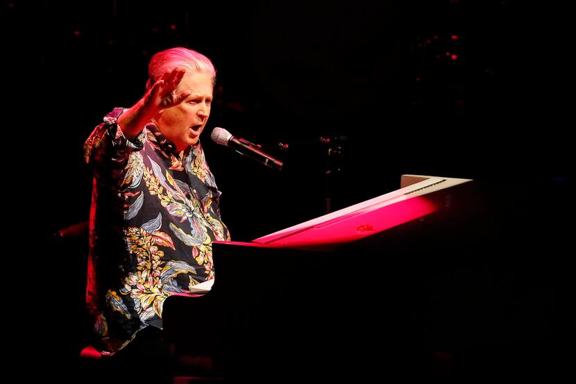 Beach Boys founding member Brian Wilson salutes the crowd as he performs at Verizon Theatre...