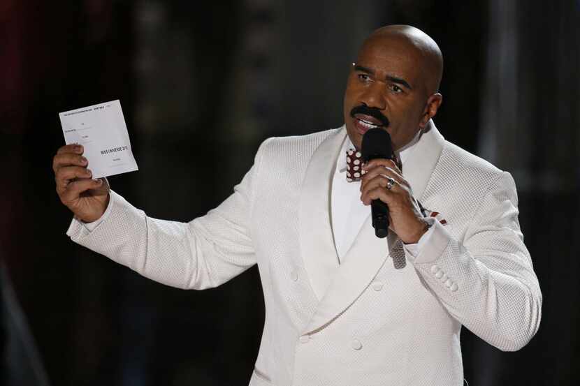 Steve Harvey holds up the card showing the winners after he incorrectly announced Miss...